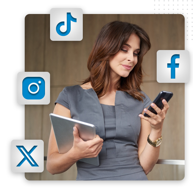 Social Media Design feat img A woman in a gray dress holds a tablet and looks at her smartphone, surrounded by social media icons—perfectly illustrating the importance of strong brand identity and effective branding solutions in today’s digital landscape.
