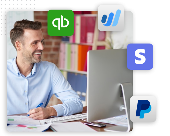 A smiling man sits at a desk working on a computer, surrounded by logos of QuickBooks, Wave, Stripe, and PayPal, suggesting he is managing finances for an automation company or integrating a CRM platform with these payment solutions.